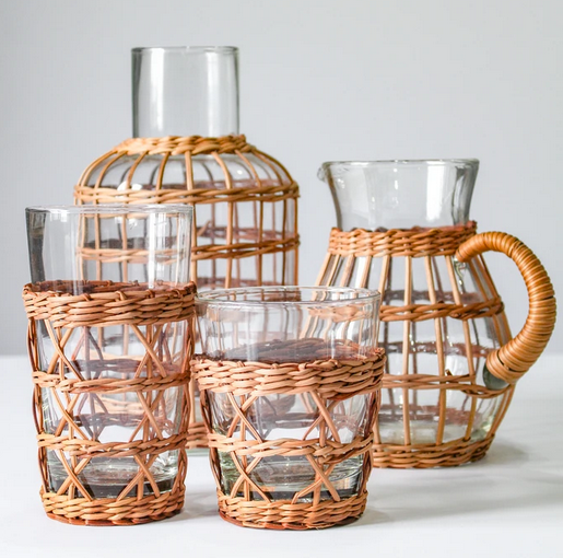 Be Home rattan cage highball glass in hand-woven rattan over clear glass, styled in a room setting