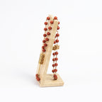 Zoya Stones Red Jasper masbaha with travertine stand, front view